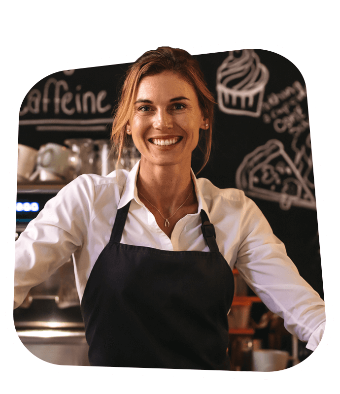 A cafe owner smiling