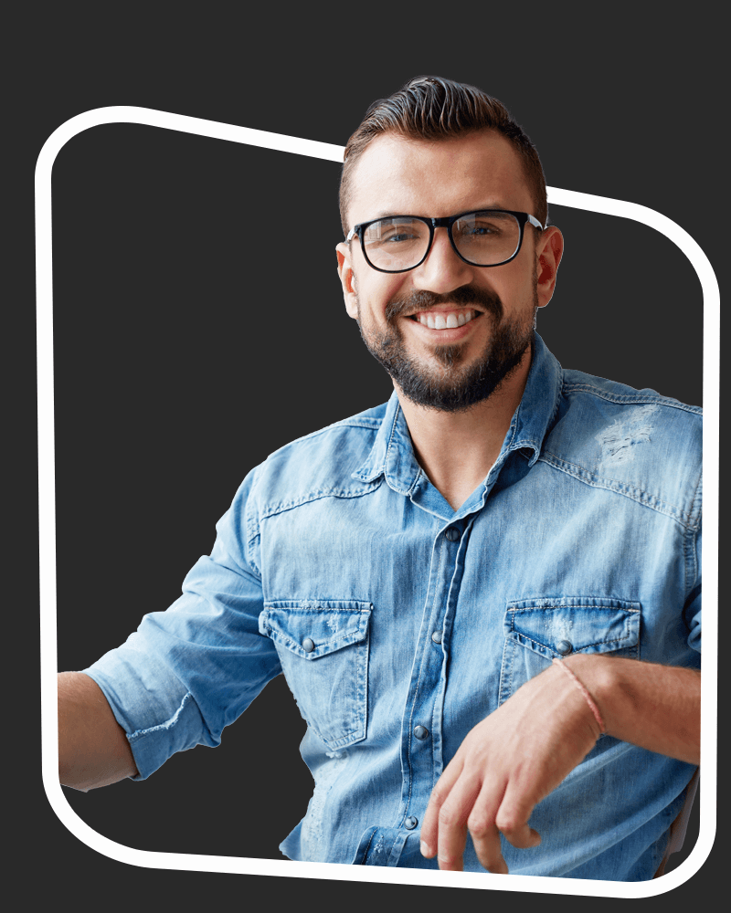 Smiling man leaning on a stool